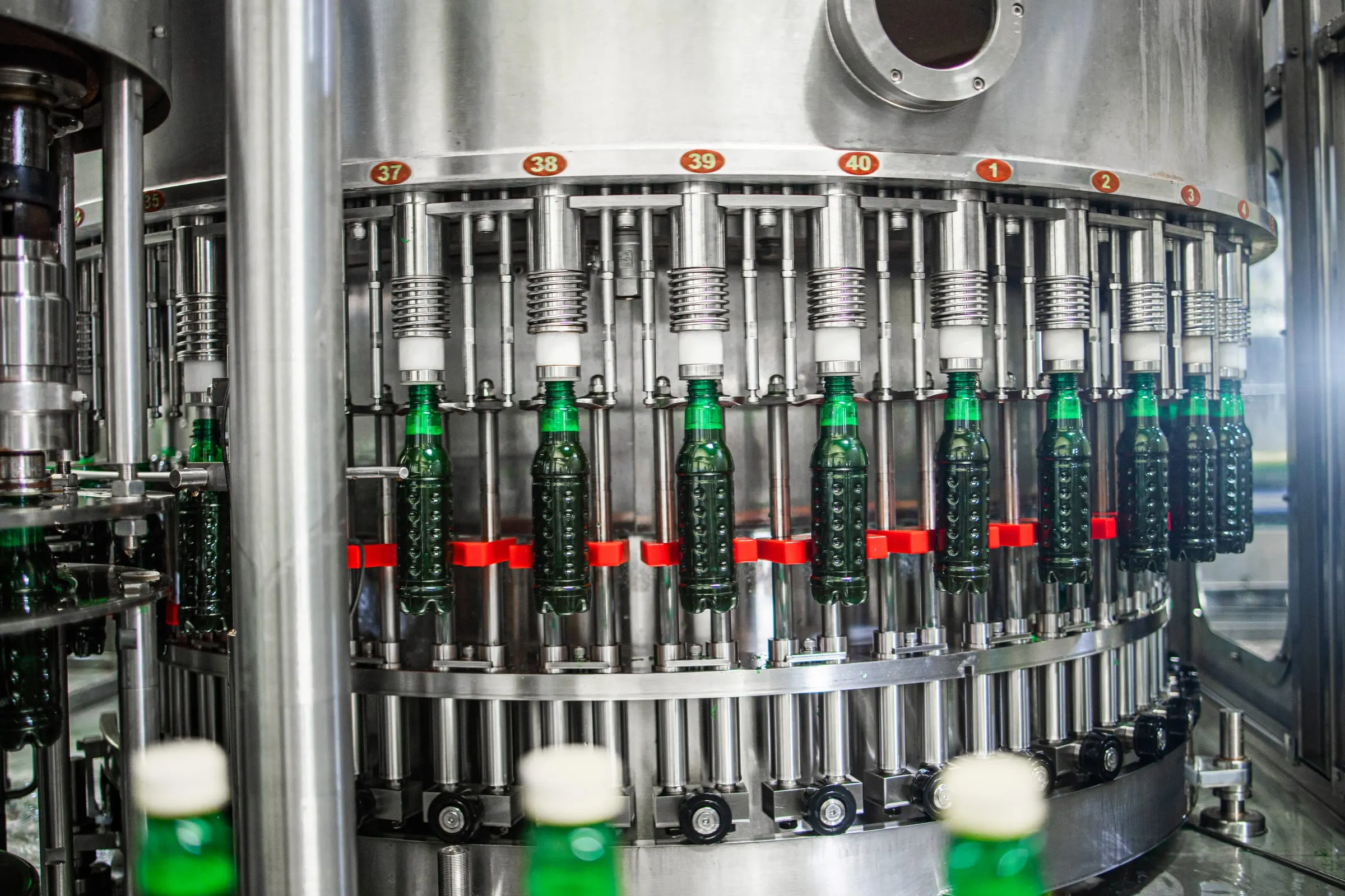 A rotary filling machine running bottles through the plant.